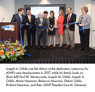 Joseph A. Oddis cuts the ribbon at the dedication ceremony for ASHP’s new headquarters in 2017, while his family looks on. (from left) Paul W. Abramowitz, Joseph M. Oddis, Joseph A. Oddis, Marie Newman, Rebecca Newman, Debra Oddis, Richard Newman, and then-ASHP President Lisa M. Gersema