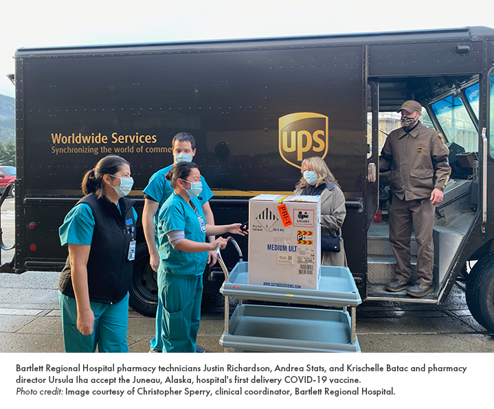 Bartlett Regional Hospital pharmacy technicians Justin Richardson, Andrea Stats, and Krischelle Batac and pharmacy director Ursula Iha accept the Juneau, Alaska, hospital's first delivery COVID-19 vaccine.