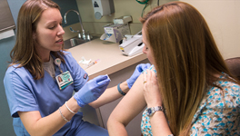 pharmacist vaccinating a patient